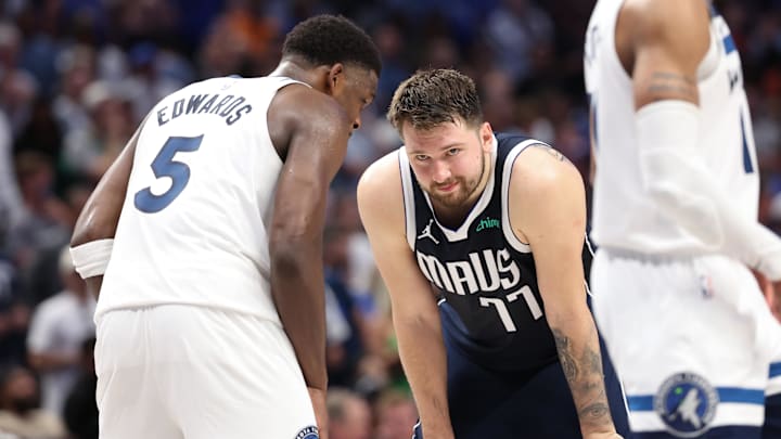 Minnesota Timberwolves guard Anthony Edwards (5) speaks to Dallas Mavericks guard Luka Doncic.