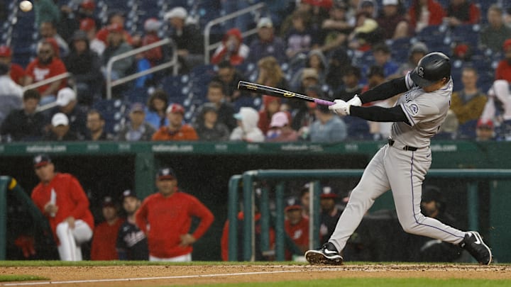 Jun 16, 2025; Washington, District of Columbia, USA; Colorado Rockies outfielder Mickey Moniak (22) hits a triple against the Washington Nationals during the fifth inning at Nationals Park. 