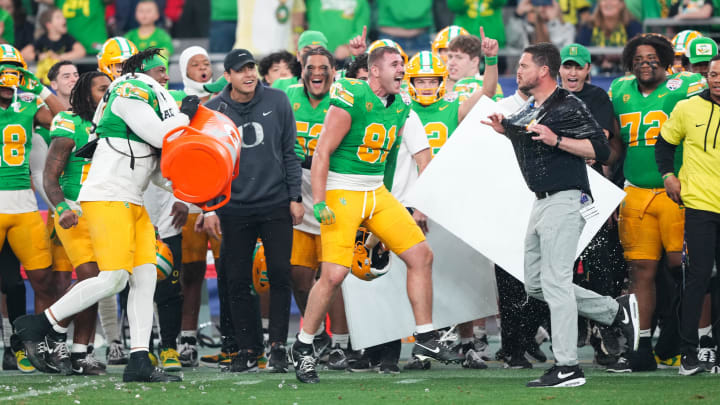 Jan 1, 2024; Glendale, AZ, USA; Oregon Ducks head coach Dan Lanning reacts after being doused in Gatorade at the end of the 2024 Fiesta Bowl against the Liberty Flames at State Farm Stadium. The Ducks won 45-6.