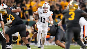 Aug 29, 2025; Waco, Texas, USA; Auburn Tigers quarterback Jackson Arnold (11) runs the ball as Baylor Bears safety Devyn Bobby (3) defends during the first half at McLane Stadium. Mandatory Credit: Chris Jones-Imagn Images