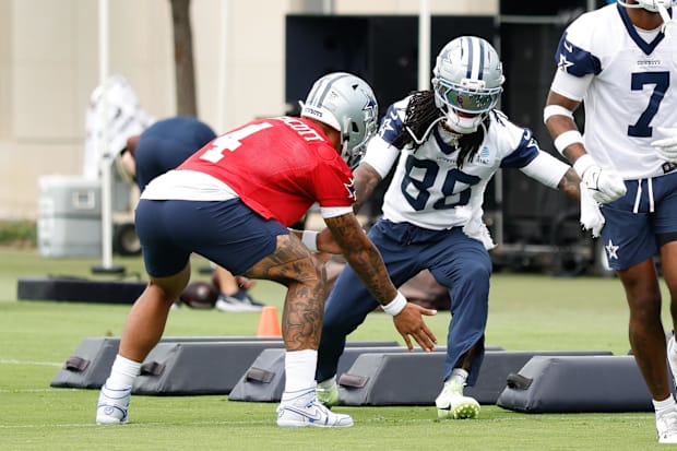 Dallas Cowboys quarterback Dak Prescott (4) celebrates with Dallas Cowboys wide receiver CeeDee Lamb (88) during a drill.
