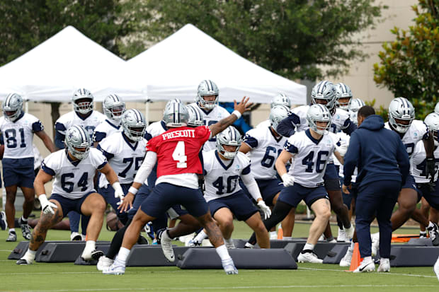 Dallas Cowboys quarterback Dak Prescott leads teammates through a drill at the Ford Center at the Star.
