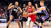 Dec 12, 2024; New Orleans, Louisiana, USA; Sacramento Kings guard Kevin Huerter (9) and center Isaac Jones (17) defend New Orleans Pelicans guard CJ McCollum (3) during the first half at Smoothie King Center. Mandatory Credit: Stephen Lew-Imagn Images
