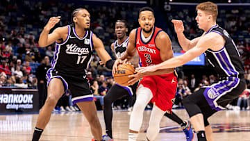 Dec 12, 2024; New Orleans, Louisiana, USA; Sacramento Kings guard Kevin Huerter (9) and center Isaac Jones (17) defend New Orleans Pelicans guard CJ McCollum (3) during the first half at Smoothie King Center. Mandatory Credit: Stephen Lew-Imagn Images