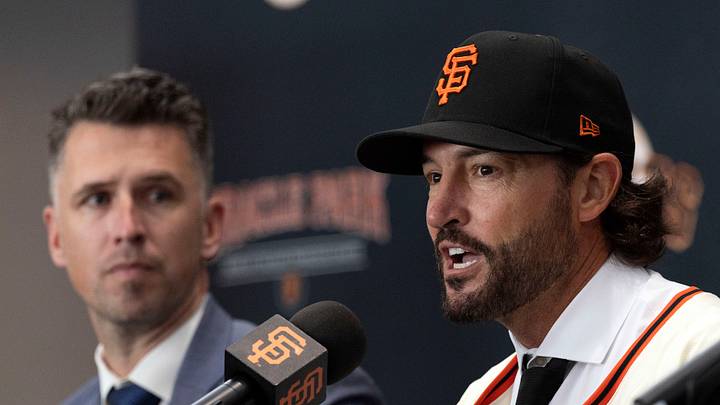 San Francisco, CA, USA;  Tony Vitello (center) answers questions from the media as he is introduced as the new manager of the San Francisco Giants at Oracle Park. He is flanked by president of baseball operations Buster Posey (left) and general manager Zack Minasian. Mandatory Credit: D. Ross Cameron-Imagn Images