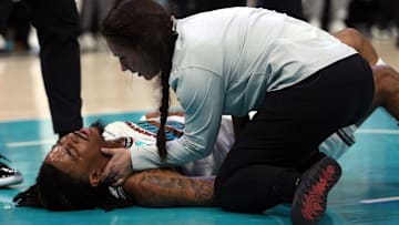 Apr 24, 2025; Memphis, Tennessee, USA; Memphis Grizzlies guard Ja Morant (12) is checked by medical staff as he lays on the court after being fouled during the second quarter against the Oklahoma City Thunder during game three for the first round of the 2024 NBA Playoffs at FedExForum. Mandatory Credit: Petre Thomas-Imagn Images