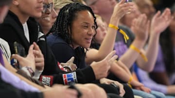 Jun 29, 2025; San Francisco, California, USA; South Carolina Gamecocks women's basketball head coach Dawn Staley (center) sits courtside during the second quarter of the game between the Golden State Valkyries and the Seattle Storm at Chase Center. Mandatory Credit: Darren Yamashita-Imagn Images