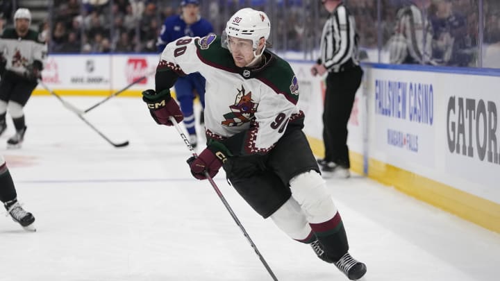 Feb 29, 2024; Toronto, Ontario, CAN; Arizona Coyotes defenseman J.J. Moser (90) carries the puck against the Toronto Maple Leafs during the third period at Scotiabank Arena. Mandatory Credit: John E. Sokolowski-USA TODAY Sports