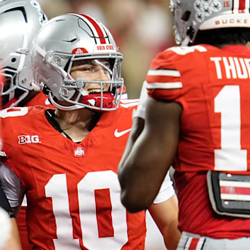 Ohio State Buckeyes quarterback Julian Sayin (10) smiles after a touchdown pass to Carnell Tate during the NCAA football game against the Minnesota Golden Gophers at Ohio Stadium in Columbus on Oct. 4, 2025.