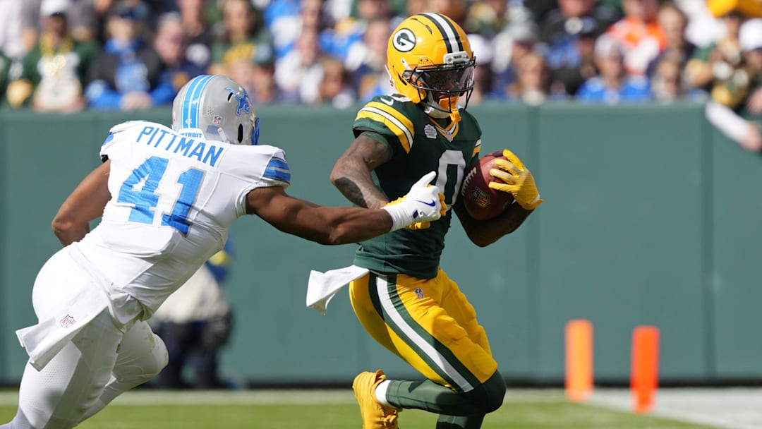 Sep 7, 2025; Green Bay, Wisconsin, USA; Green Bay Packers wide receiver Matthew Golden (0) runs with the ball against Detroit Lions linebacker Anthony Pittman (41) during the first quarter at Lambeau Field. Mandatory Credit: Jeff Hanisch-Imagn Images