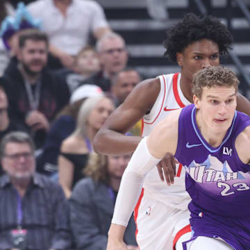 Feb 22, 2025; Salt Lake City, Utah, USA; Utah Jazz forward Lauri Markkanen (23) brings the ball up the court against Houston Rockets forward Amen Thompson (back) during the first half at Delta Center. Mandatory Credit: Rob Gray-Imagn Images