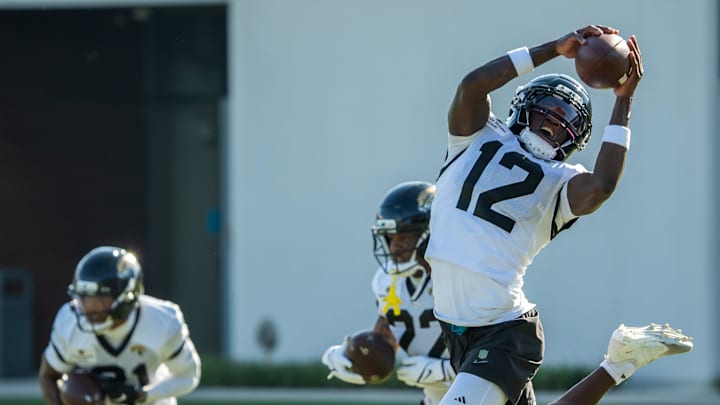 Jacksonville Jaguars wide receiver Travis Hunter (12) hails in a pass while running a drill during an NFL training camp fourth session at the Miller Electric Center, Sunday, July 27, 2025, in Jacksonville, Fla. [Doug Engle/Florida Times-Union]