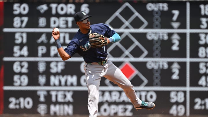 May 26, 2024; Washington, District of Columbia, USA; Seattle Mariners second baseman Jorge Polanco (7) attempts a throw to first base against the Washington Nationals during the second inning at Nationals Park. Mandatory Credit: Rafael Suanes-USA TODAY Sports