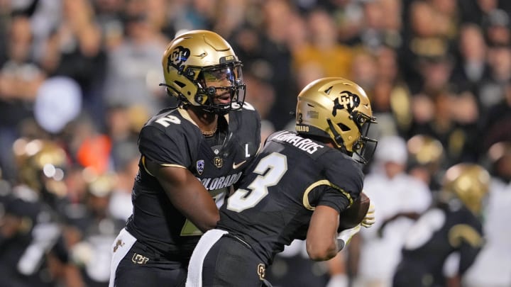 Sep 16, 2023; Boulder, Colorado, USA; Colorado Buffaloes quarterback Shedeur Sanders (2) hands off the ball to running back Dylan Edwards (3) against the Colorado State Rams during the first half at Folsom Field. Mandatory Credit: Andrew Wevers-USA TODAY Sports