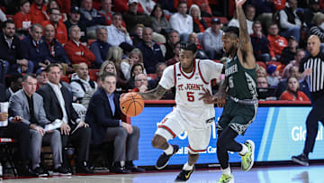 Nov 13, 2024; Queens, New York, USA;  St. John's basketball guard Deivon Smith (5) drives past Wagner Seahawks guard Zae Blake (5) in the second half at Carnesecca Arena.