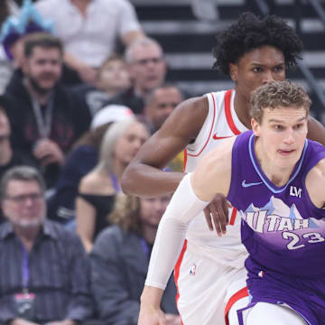 Feb 22, 2025; Salt Lake City, Utah, USA; Utah Jazz forward Lauri Markkanen (23) brings the ball up the court against Houston Rockets forward Amen Thompson (back) during the first half at Delta Center. Mandatory Credit: Rob Gray-Imagn Images