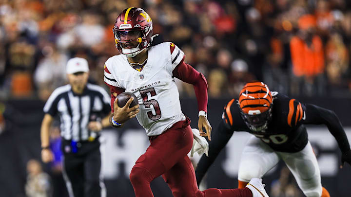 Washington Commanders quarterback Jayden Daniels runs with the ball against the Cincinnati Bengals in the second half at Paycor Stadium.