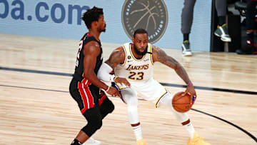 Oct 11, 2020; Lake Buena Vista, Florida, USA; Los Angeles Lakers forward LeBron James (23) dribbles while defended by Miami Heat forward Jimmy Butler (22) during the third quarter in game six of the 2020 NBA Finals at AdventHealth Arena. Mandatory Credit: Kim Klement-Imagn Images