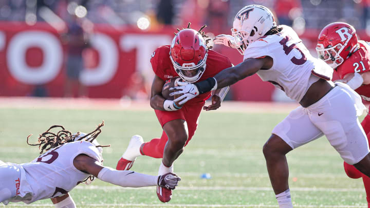 Sep 16, 2023; Piscataway, New Jersey, USA; Rutgers Scarlet Knights quarterback Gavin Wimsatt (2) is tackled by Virginia Tech Hokies safety Jalen Stroman (26) and defensive lineman Antwaun Powell-Ryland (52) during the first half at SHI Stadium. Mandatory Credit: Vincent Carchietta-USA TODAY Sports