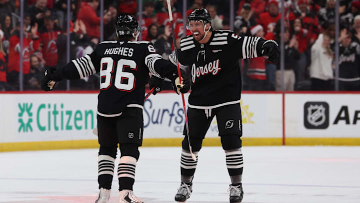 Dec 21, 2025; Newark, New Jersey, USA;  New Jersey Devils defenseman Brenden Dillon (5) celebrates the goal by New Jersey Devils center Jack Hughes (86) against the Buffalo Sabres during the first period at Prudential Center. Mandatory Credit: Thomas Salus-Imagn Images