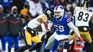 Jan 15, 2024; Orchard Park, New York, USA; Buffalo Bills long snapper Reid Ferguson (69) and Pittsburgh Steelers wide receiver Calvin Austin III (19) on a punt return in the third quarter of a 2024 AFC wild card game