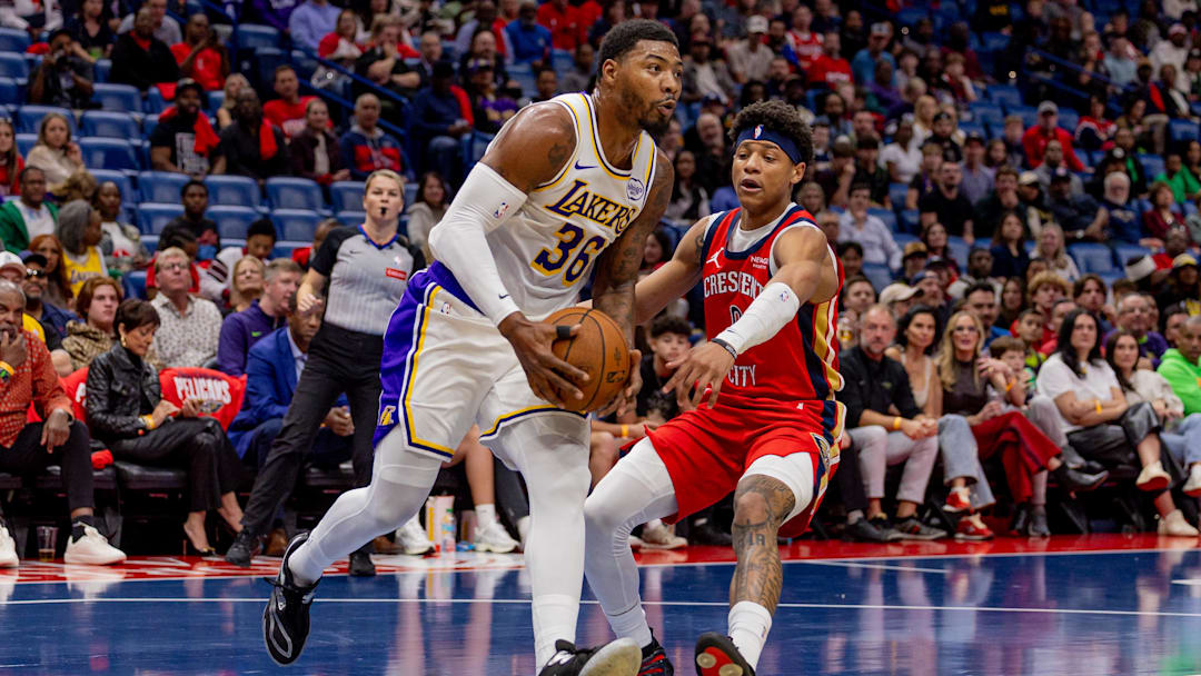 Nov 14, 2025; New Orleans, Louisiana, USA;  Los Angeles Lakers guard Marcus Smart (36) drives to the basket against New Orleans Pelicans guard Jeremiah Fears (0) during the first half at Smoothie King Center. Mandatory Credit: Stephen Lew-Imagn Images