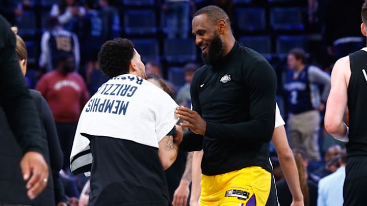 Mar 27, 2024; Memphis, Tennessee, USA; Memphis Grizzlies guard Scotty Pippen Jr. (1) and Los Angeles Lakers forward LeBron James (23) embrace after the game at FedExForum. Mandatory Credit: Petre Thomas-Imagn Images