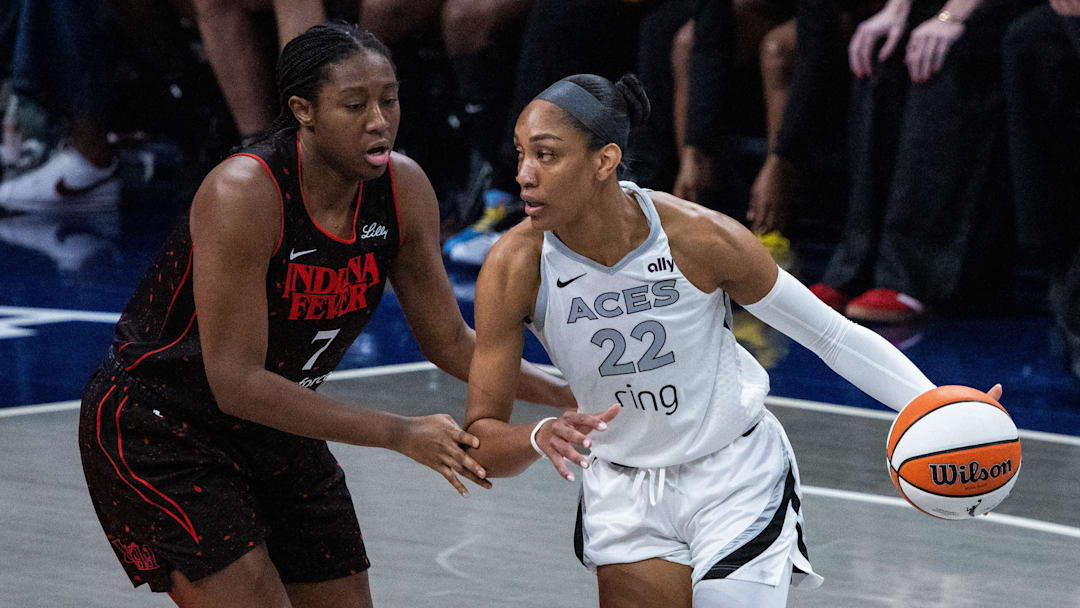 Sep 28, 2025; Indianapolis, Indiana, USA; Las Vegas Aces center A'ja Wilson (22) dribbles the ball while Indiana Fever forward Aliyah Boston (7) defends in the first half  during game four of the second round for the 2025 WNBA Playoffs at Gainbridge Fieldhouse. Mandatory Credit: Trevor Ruszkowski-Imagn Images
