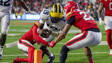 Nov 22, 2025; College Park, Maryland, USA;  Michigan Wolverines quarterback Bryce Underwood (19) dives towards the pilon as Maryland Terrapins defensive back Jalen Huskey (22) tackles during the second half at SECU Stadium. Mandatory Credit: Tommy Gilligan-Imagn Images