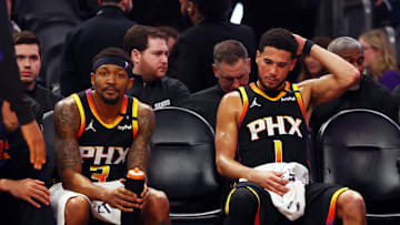 Apr 9, 2025; Phoenix, Arizona, USA; Phoenix Suns guard Bradley Beal (3) and guard Devin Booker (1) react on the bench against the Oklahoma City Thunder during the fourth quarter at Footprint Center. Mandatory Credit: Mark J. Rebilas-Imagn Images