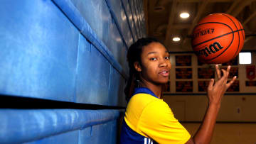 Divine Bourrage spins a basketball on her finger Wednesday, Nov. 29, 2023, at Davenport North High School.