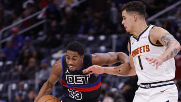 Nov 20, 2023; Detroit, Michigan, USA;  Detroit Pistons guard Jaden Ivey (23) dribbles defended by Denver Nuggets forward Michael Porter Jr. (1):  Rick Osentoski-USA TODAY Sports