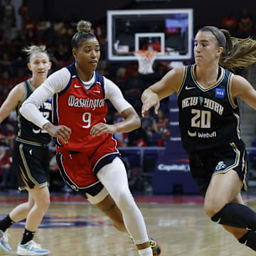 May 19, 2023; Washington, District of Columbia, USA; New York Liberty guard Sabrina Ionescu (20) drives to the basket as Washington Mystics guard Natasha Cloud (9) defends at Entertainment & Sports Arena. Mandatory Credit: Geoff Burke-Imagn Images