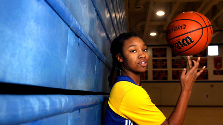 Divine Bourrage spins a basketball on her finger Wednesday, Nov. 29, 2023, at Davenport North High School.