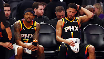Apr 9, 2025; Phoenix, Arizona, USA; Phoenix Suns guard Bradley Beal (3) and guard Devin Booker (1) react on the bench against the Oklahoma City Thunder during the fourth quarter at Footprint Center. Mandatory Credit: Mark J. Rebilas-Imagn Images