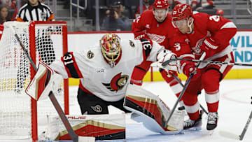 Oct 4, 2024; Detroit, Michigan, USA;  Ottawa Senators goaltender Anton Forsberg (31) makes a save on Detroit Red Wings left wing Lucas Raymond (23) in the second period at Little Caesars Arena. Mandatory Credit: Rick Osentoski-Imagn Images