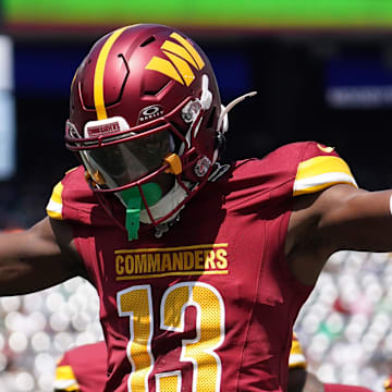 Aug 10, 2024; East Rutherford, New Jersey, USA; Washington Commanders cornerback Emmanuel Forbes (13) celebrates after breaking up a pass to New York Jets wide receiver Mike Williams (18) during the first quarter at MetLife Stadium. Mandatory Credit: Lucas Boland-Imagn Images