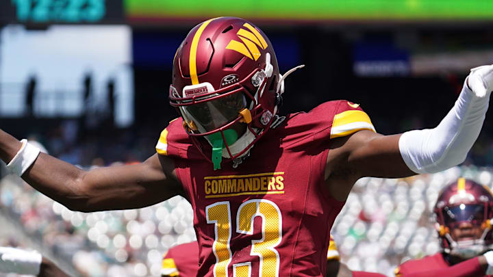 Aug 10, 2024; East Rutherford, New Jersey, USA; Washington Commanders cornerback Emmanuel Forbes (13) celebrates after breaking up a pass to New York Jets wide receiver Mike Williams (18) during the first quarter at MetLife Stadium. Mandatory Credit: Lucas Boland-Imagn Images