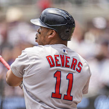 Boston Red Sox designated hitter Rafael Devers (11) follows through after hitting a double against the Atlanta Braves during the first inning at Truist Park on June 1.