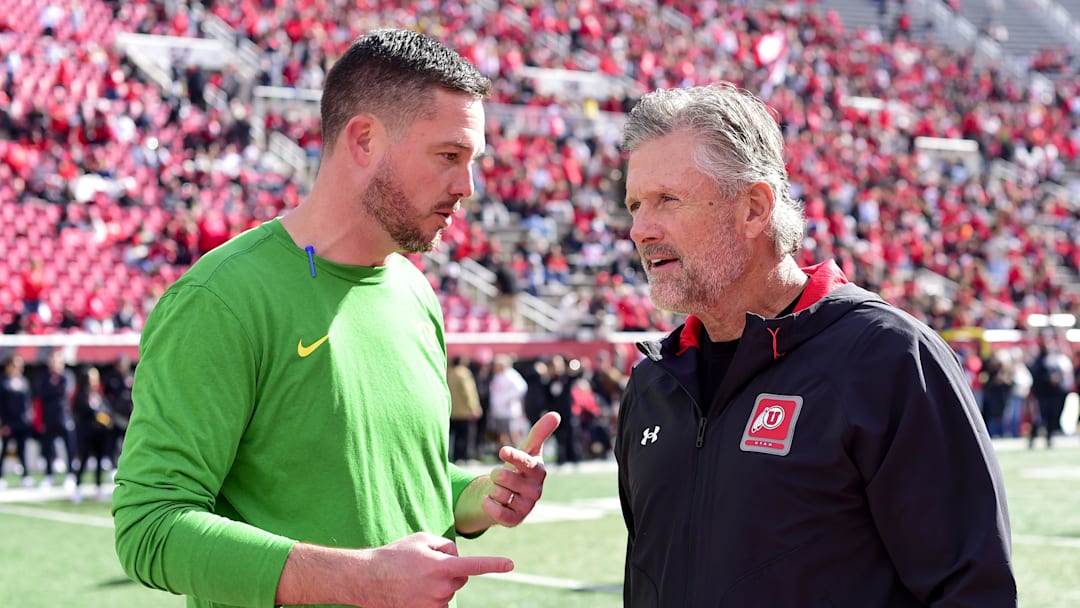 Oct 28, 2023; Salt Lake City, Utah, USA; Oregon Ducks head coach Dan Lanning speaks with Utah Utes head coach Kyle Whittingham before a game at Rice-Eccles Stadium. Mandatory Credit: Christopher Creveling-Imagn Images