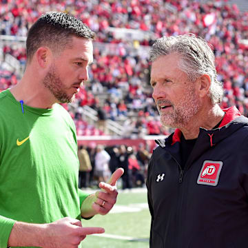 Oct 28, 2023; Salt Lake City, Utah, USA; Oregon Ducks head coach Dan Lanning speaks with Utah Utes head coach Kyle Whittingham before a game at Rice-Eccles Stadium. Mandatory Credit: Christopher Creveling-Imagn Images