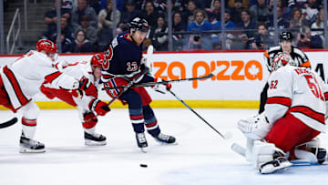 Feb 4, 2025; Winnipeg, Manitoba, CAN;  Carolina Hurricanes forward Jasckson Blake (53) checks Winnipeg Jets forward Gabriel Vilardi (13) during the second period at Canada Life Centre. Mandatory Credit: Terrence Lee-Imagn Images