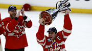Team Canada forward Sidney Crosby lifts the 4 Nations Face-Off trophy after winning against Team USA in overtime.