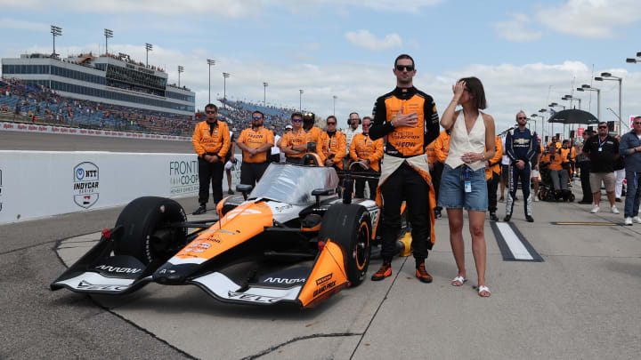 Jul 14, 2024; Newton, Iowa, USA; Arrow McLaren SP driver Alexander Rossi (7) of United States stands at attention during the playing of the National Anthem during the Hy-Vee Homefront 250 at Iowa Speedway. Mandatory Credit: Reese Strickland-USA TODAY Sports