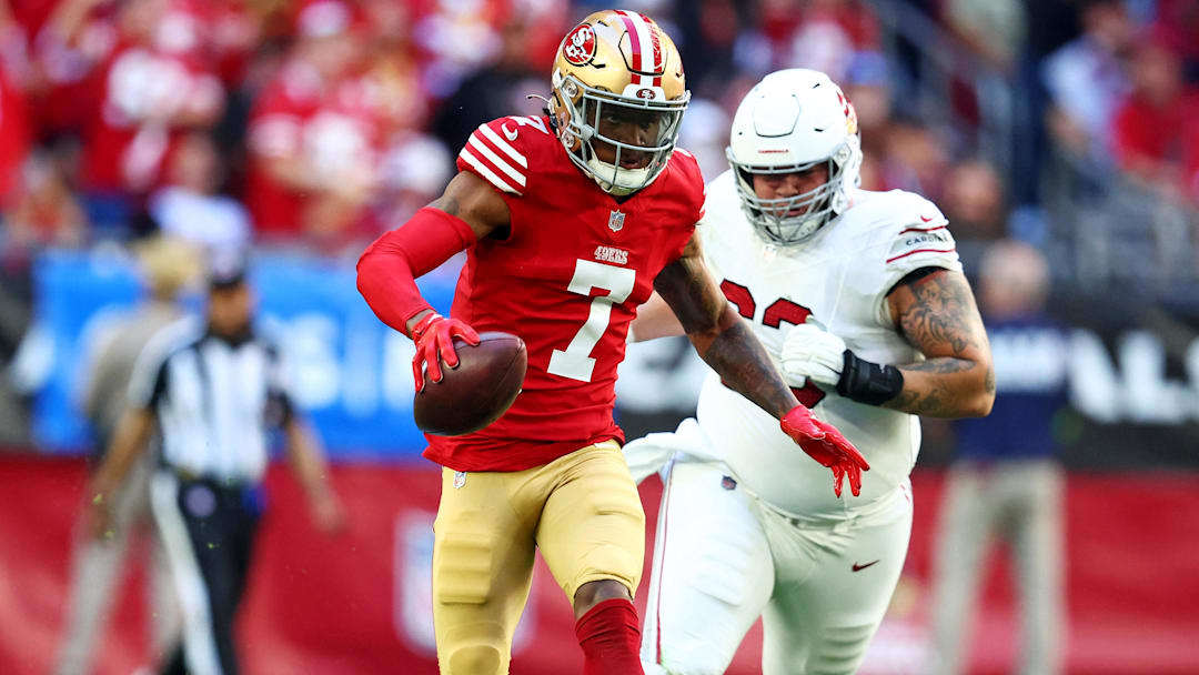 Dec 17, 2023; Glendale, Arizona, USA; San Francisco 49ers cornerback Charvarius Ward (7) runs back an interceptions for a touchdown  during the first quarter against the Arizona Cardinals at State Farm Stadium. Mandatory Credit: Mark J. Rebilas-Imagn Images