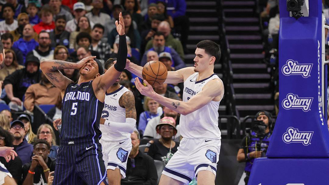 Feb 21, 2025; Orlando, Florida, USA; Orlando Magic forward Paolo Banchero (5) is fouled by Memphis Grizzlies guard Ja Morant (12) during the second half at Kia Center. Mandatory Credit: Mike Watters-Imagn Images Feb 21, 2025; Orlando, Florida, USA; Orlando Magic forward Paolo Banchero (5) is fouled by Memphis Grizzlies guard Ja Morant (12) during the second half at Kia Center. Mandatory Credit: Mike Watters-Imagn Images