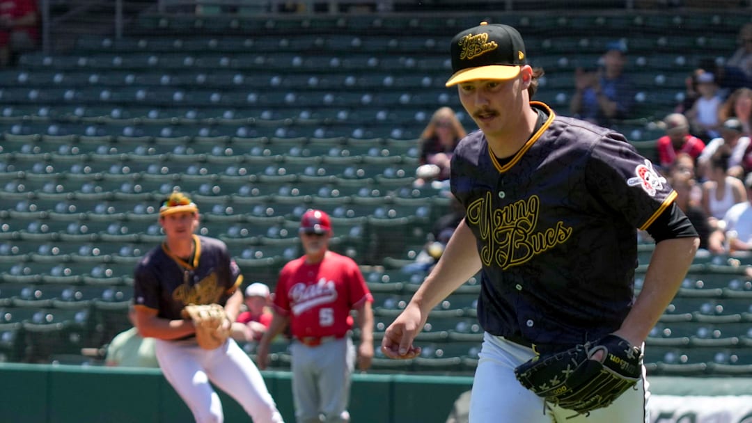 Indianapolis Indians starting pitcher Bubba Chandler goes after a ball hit by Louisville Bats outfielder Jacob Hurtubise.