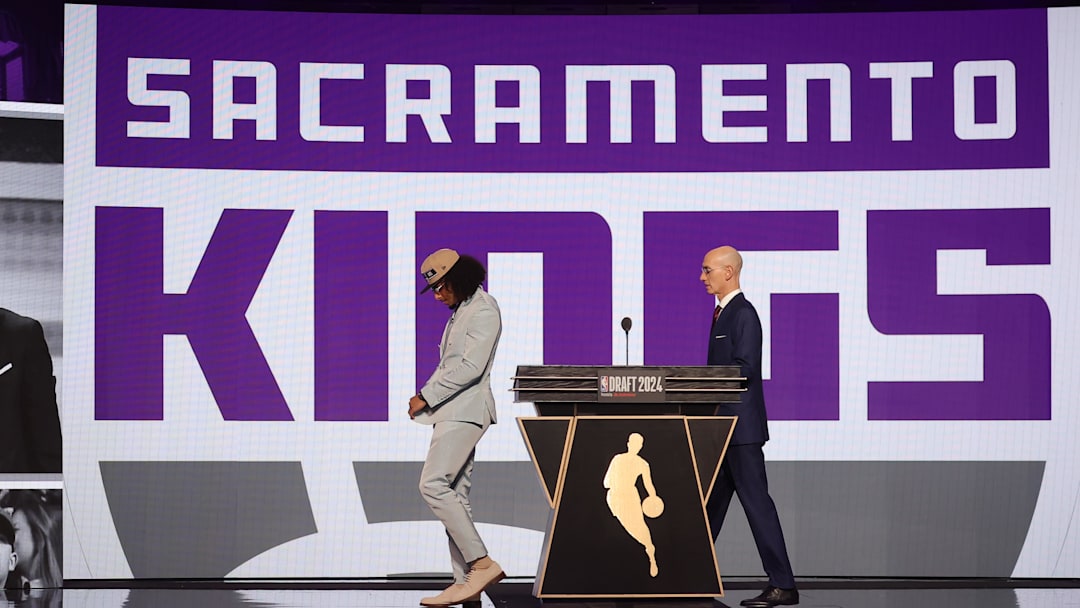 Jun 26, 2024; Brooklyn, NY, USA; Devin Carter walks on stage after being selected in the first round by the Sacramento Kings in the 2024 NBA Draft at Barclays Center.