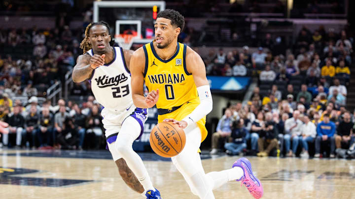 Mar 31, 2025; Indianapolis, Indiana, USA; Indiana Pacers guard Tyrese Haliburton (0) dribbles the ball while  Sacramento Kings guard Keon Ellis (23) defends in the first half at Gainbridge Fieldhouse. Mandatory Credit: Trevor Ruszkowski-Imagn Images