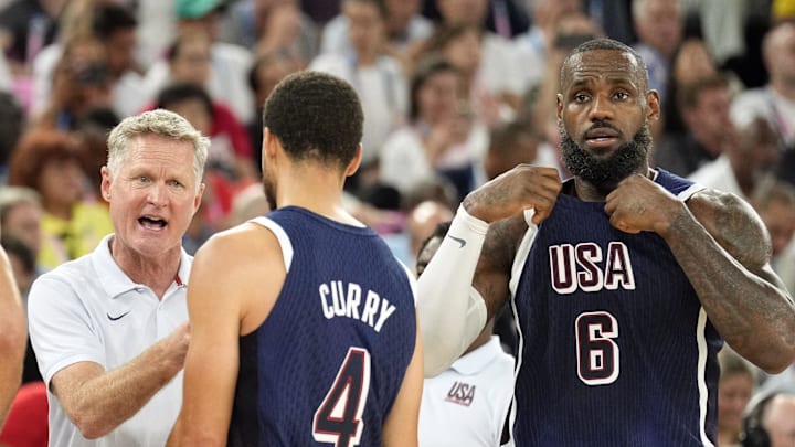 Aug 6, 2024; Paris, France; United States head coach Steve Kerr talks to centre Joel Embiid (11) and small forward Jayson Tatum (10) and shooting guard Stephen Curry (4) and guard LeBron James (6) in the first half against Brazil in a men’s basketball quarterfinal game during the Paris 2024 Olympic Summer Games at Accor Arena. 